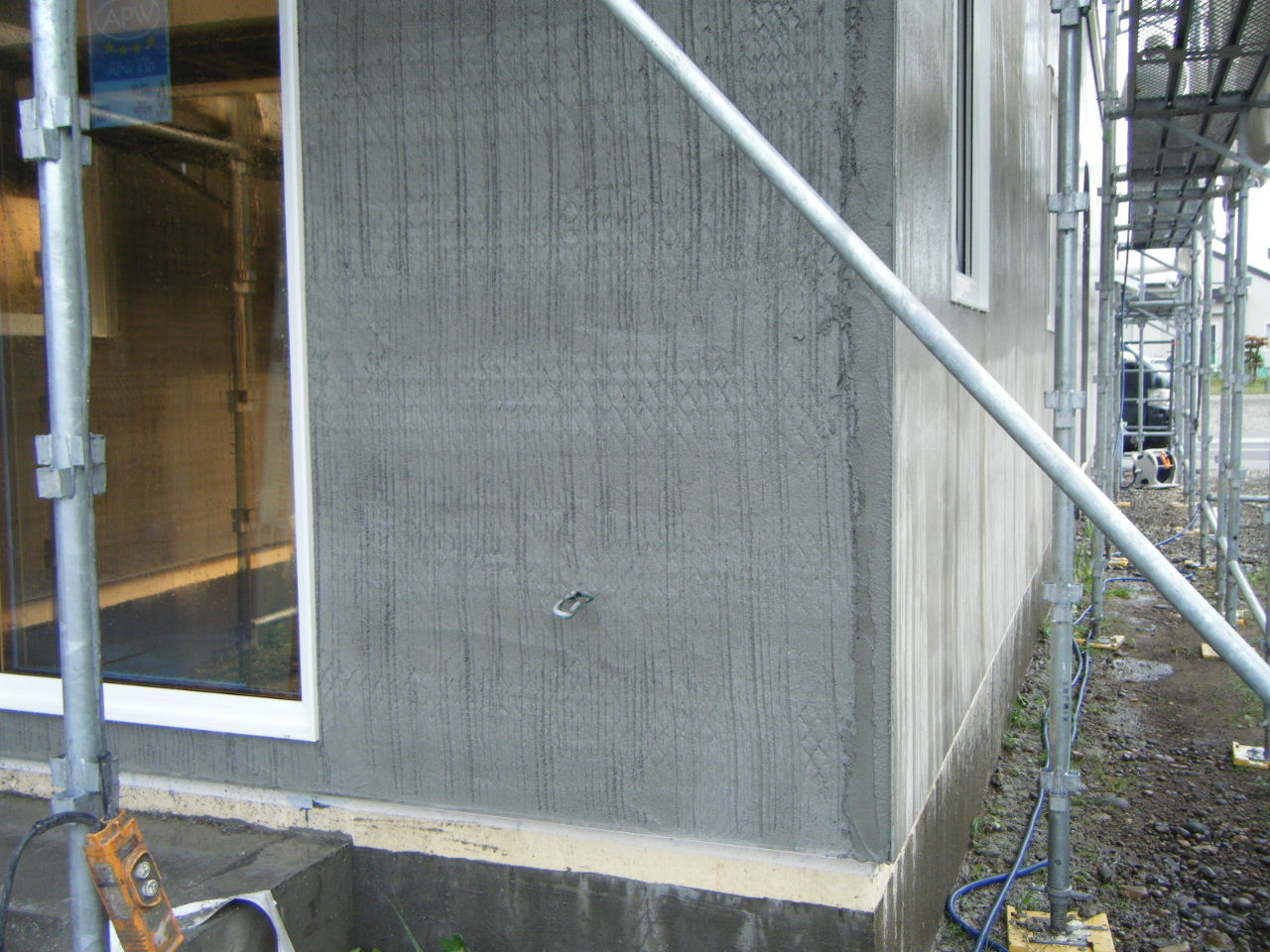 外壁モルタル2回目、ガラス繊維のシートを挟んで3回目を塗ります。